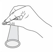 A hand squeezes the inner ring of the internal condom.