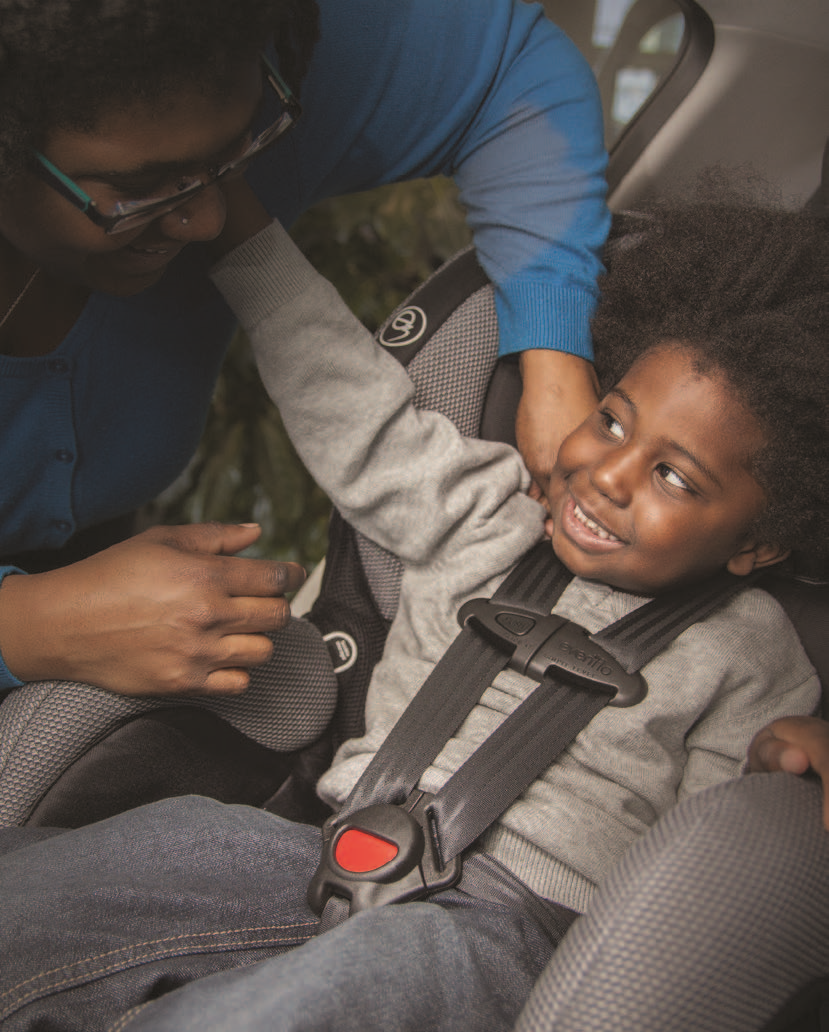 Young child buckled into a car seat with a 5-point harness facing the front of the car.