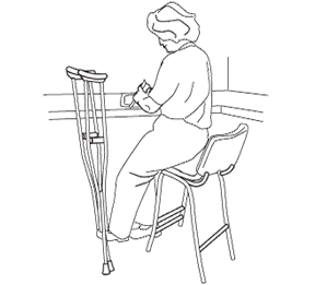 Woman sitting on a high stool working at a counter.