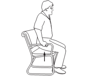 Person sitting in chair with feet flat on floor, pushing up with both arms to lift off seat.
