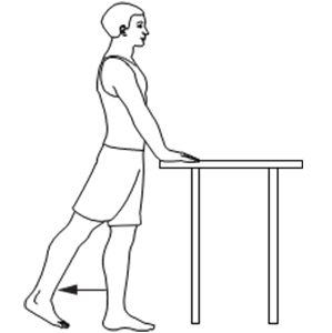 Person standing, holding onto table for support, slowly moving 1 leg backward.
