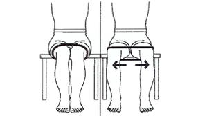 Person sitting on a chair with a rubber band holding their knees together. Person is spreading knees against the tension of the rubber band.