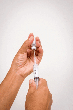 Syringe being filled from a vial.