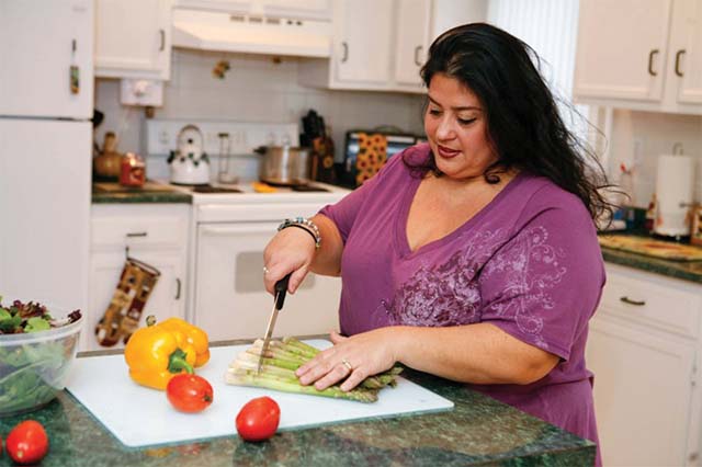 Person chopping vegetables in their kitchen.