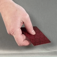 Person moving fingers to spread out cards held in hand.