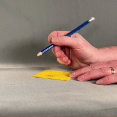 Hand holding and adjusting pencil to get ready to write.