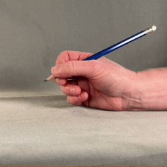 Side view of hand holding a pencil. Fingers are moving the pencil up and down.
