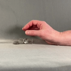 Close up of hand picking up a coin and hiding it in the palm.