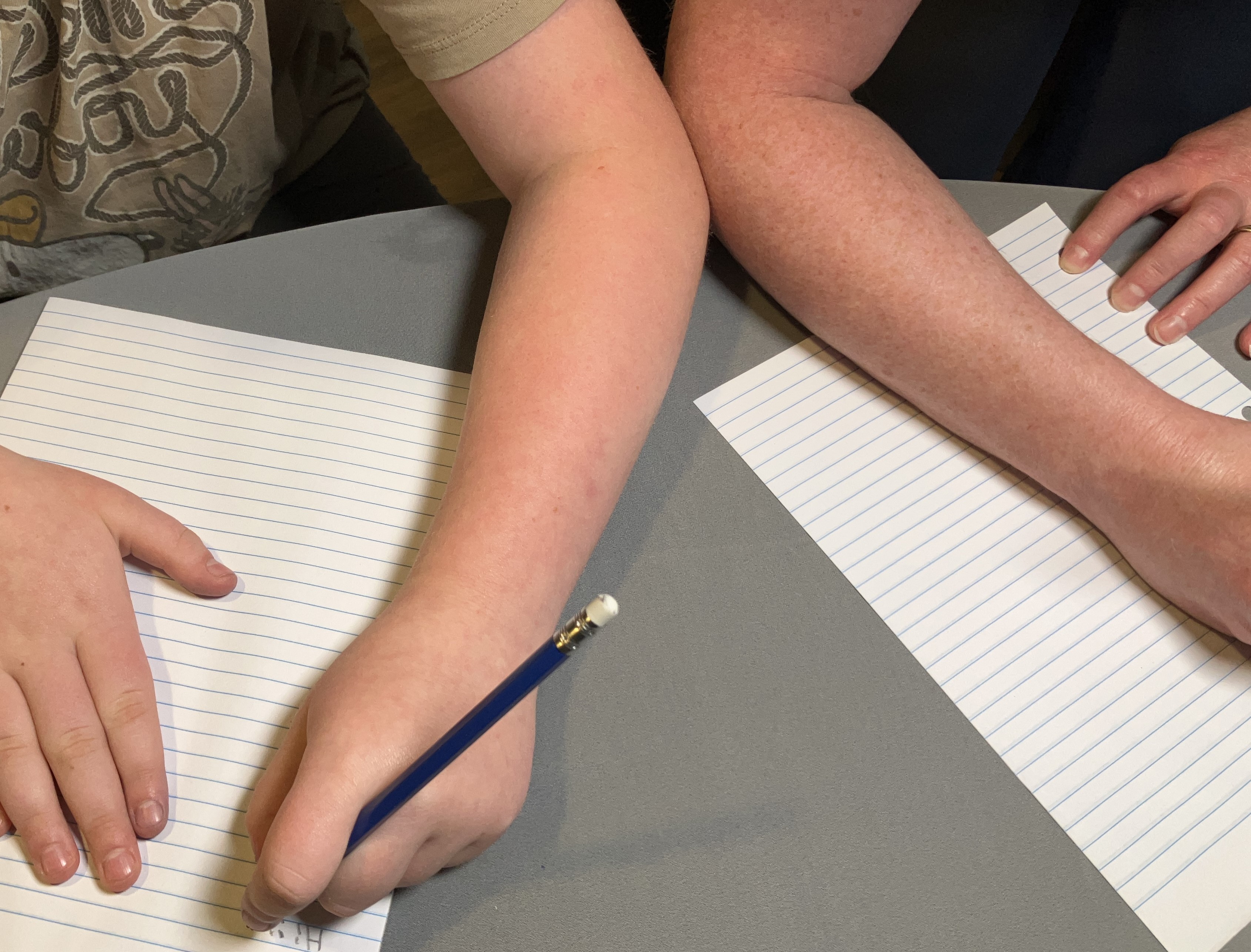 Left-handed and right-handed people bumping elbows when seated next to each other. 